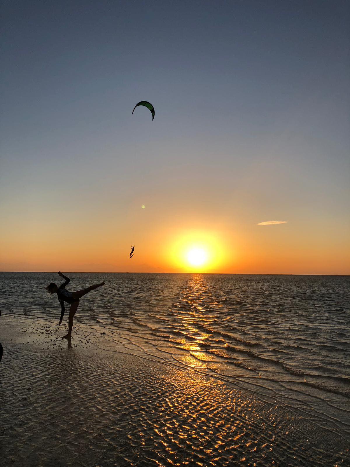 Yoga on the beach and kters in the water. Evening in the Red Sea